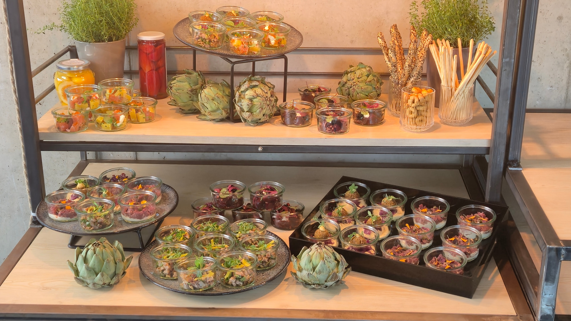 Fingerfood, Salate und kleine Speisen auf einem mehrstöckigen Buffetregal.